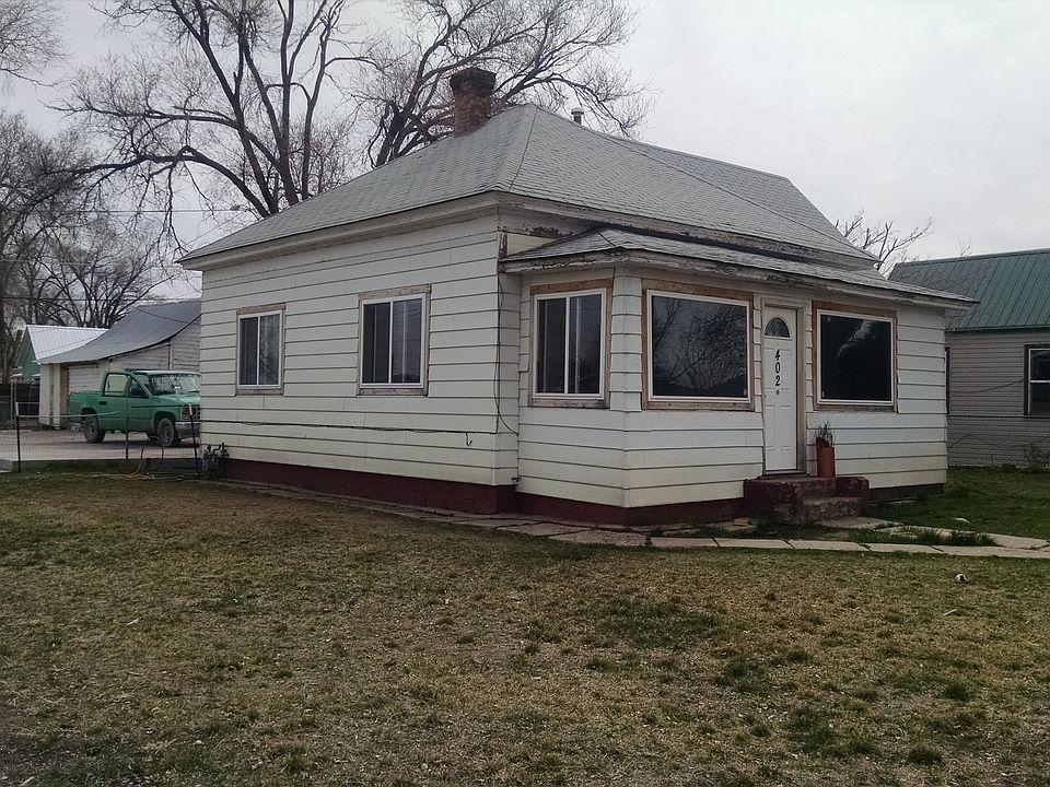 Side View of House, Shed can be seen behind the green truck