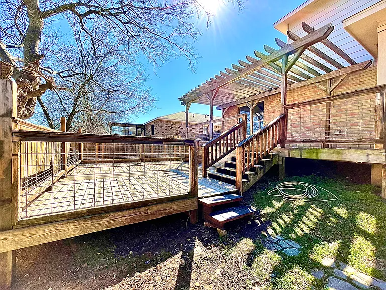 Backyard comes with two large wooden decks and a pergola patio