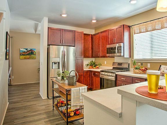 Cherrywood kitchen cabinet with stainless steel appliances