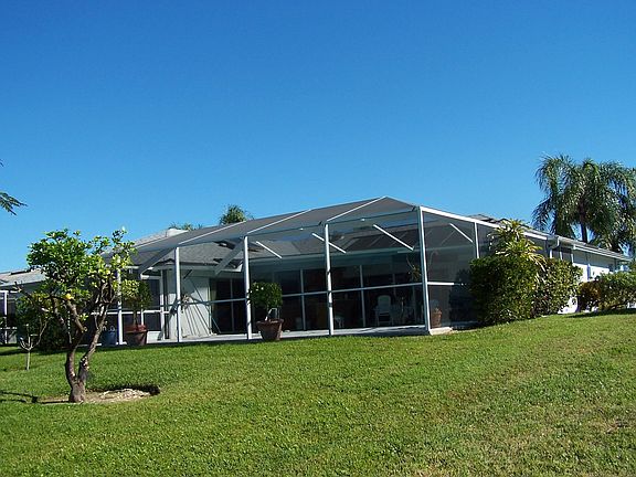 House rear with cathedral pool cage