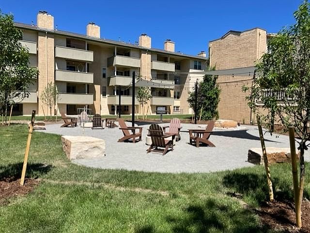 outdoor social gathering space with chairs, grills, and firepits