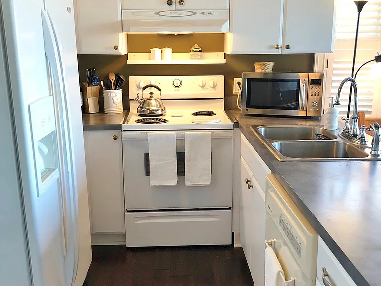 Fully supplied kitchen with dishwasher, microwave, keurig or drip coffeemaker, ice and filtered water dispenser, garbage disposal, full set of cooking equipment and serving dishes.