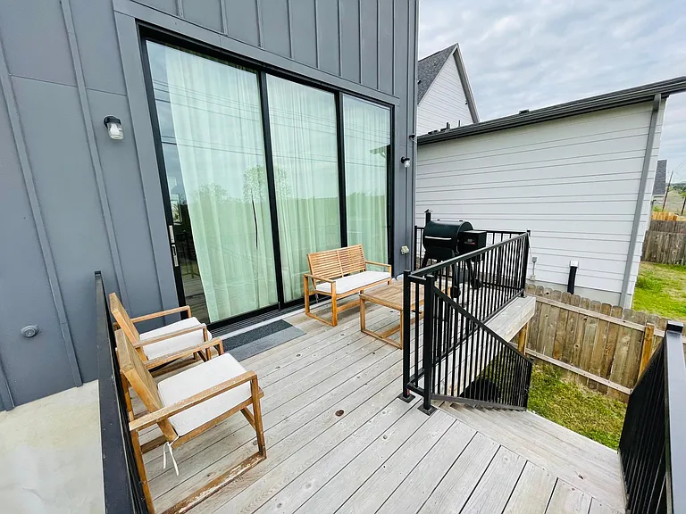 Rear deck with stairs down to large grassy yard