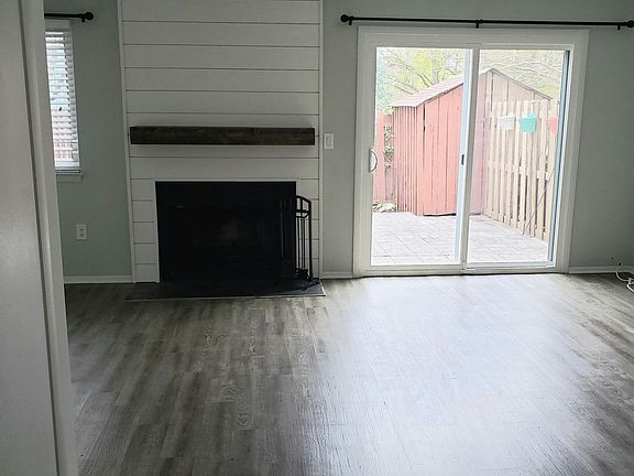 Wood burning fireplace with shiplap and wood mantle. Easy to clean wood vinyl plank flooring.
