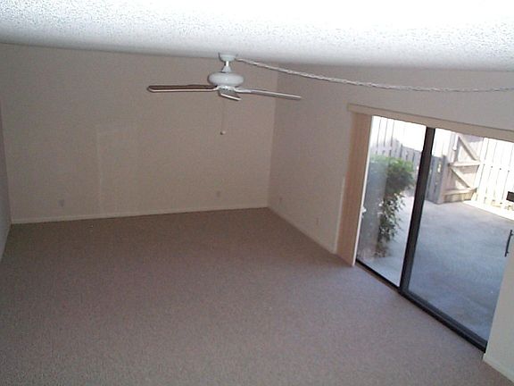 Large living room with sliding glass doors to patio...