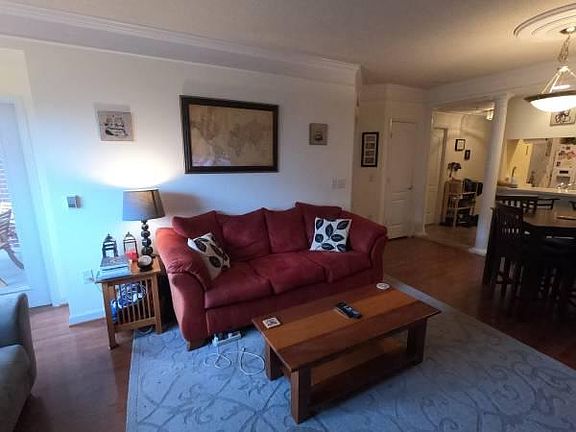Living room with entryway in background (balcony to the left)