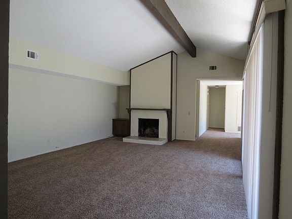 living room with high ceiling and fireplace.