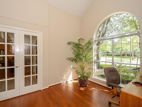 French doors lead into this study with hardwood flooring.