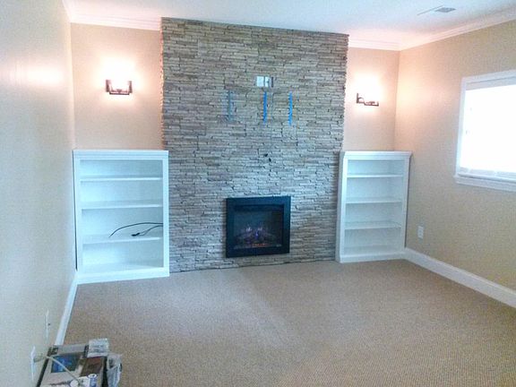 Electric fireplace. TV support is now in place over fireplace.