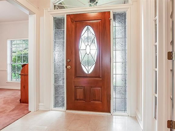 Entryway has Marble Floors and it Flanked by the Formal Dining Room and Study, but You can See all the way Through to the Den.
