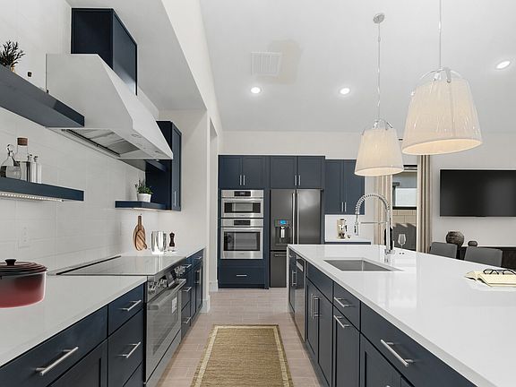 Kitchen with blue cabinets and quartz countertops