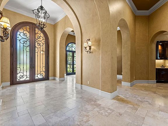 View of the entry. The formal dining room is located on the right and the hallway to the right leads you to the wine room and then to the kitchen and additional living space.