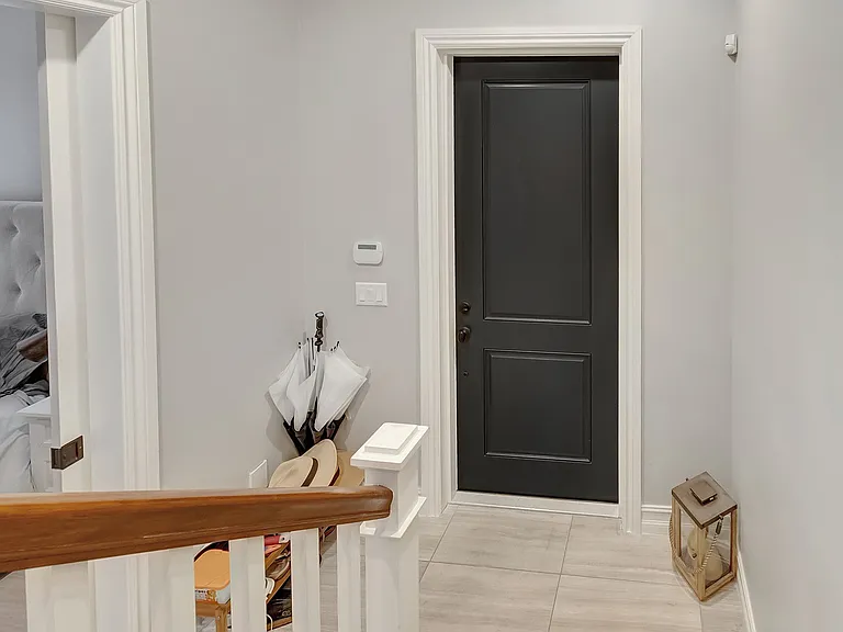 View down 1st floor stairs to front door