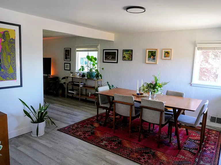View of dining room from kitchen. Lots of light.