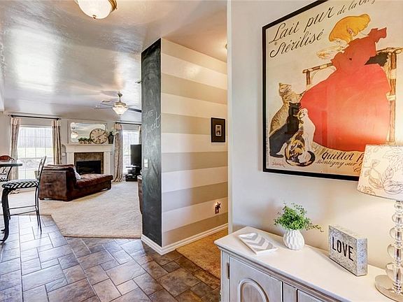 Entry, looking into the living area with a view of the hallway, to the right.