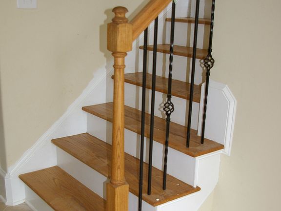 Oak staircase with wrought iron balusters.