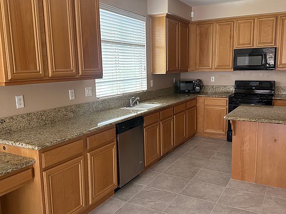 kitchen next to great room. lots of shelving and storage space