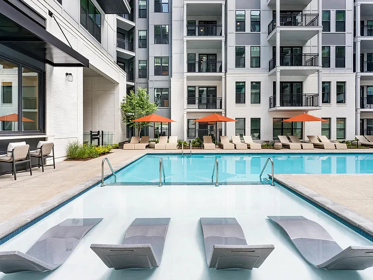 Sunbathe in the resort-style pool's tanning ledge or lounge poolside under vibrant umbrellas_your retreat is just steps from home.
