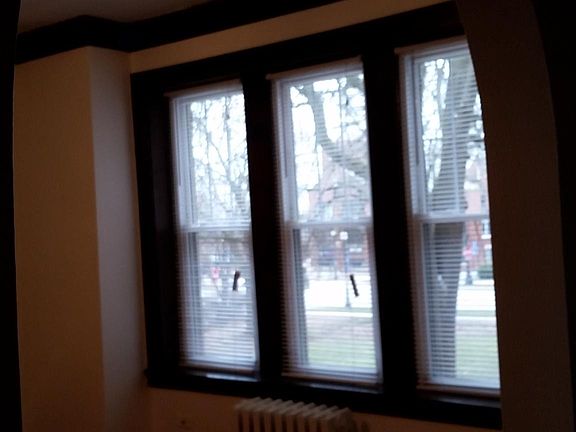 View of the living room from the hallway, with a view outside to the front courtyard.