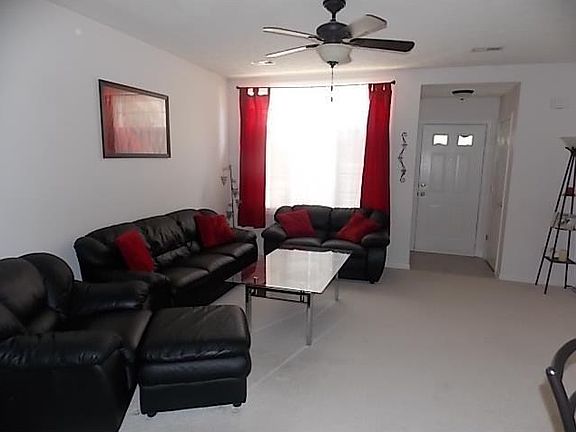 Family Room. Second angle of family room facing front door and newer vinyl entry.