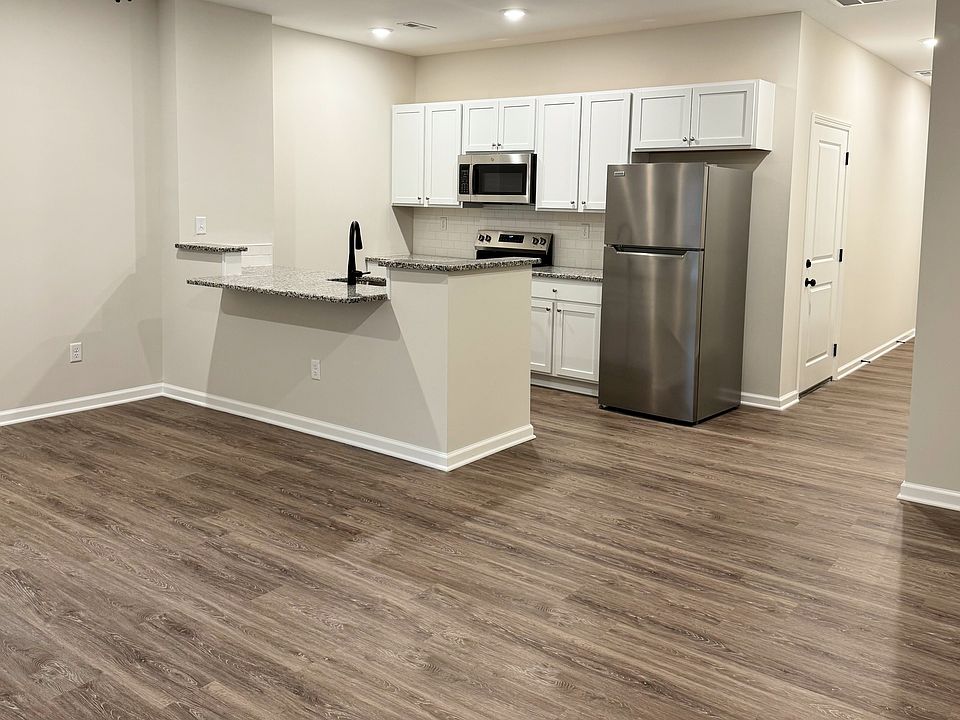 Spacious open-concept living area with brand new floors and plenty of natural light.