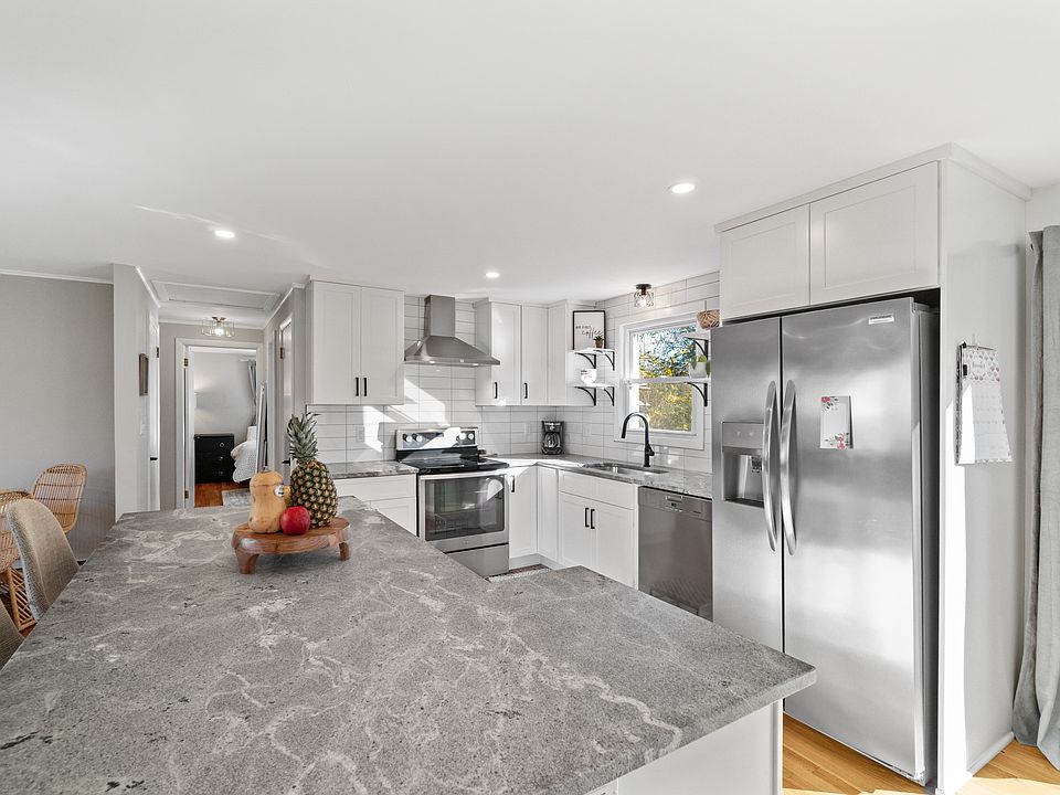 Renovated kitchen with oversized island stainless steel appliances