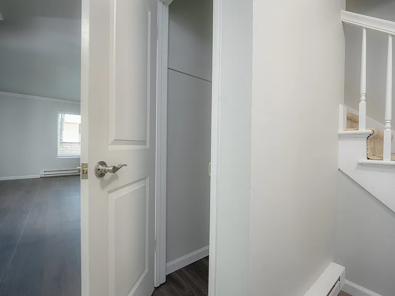 Step into elegance with this welcoming room and stylish staircase, perfect for modern living.