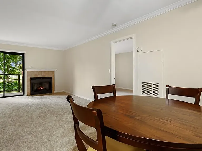 View from dining area into living room. Sliding doors provide ample natural light.
