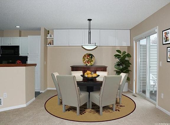 Dining Area with sliding glass door to deck and built-in cabinets