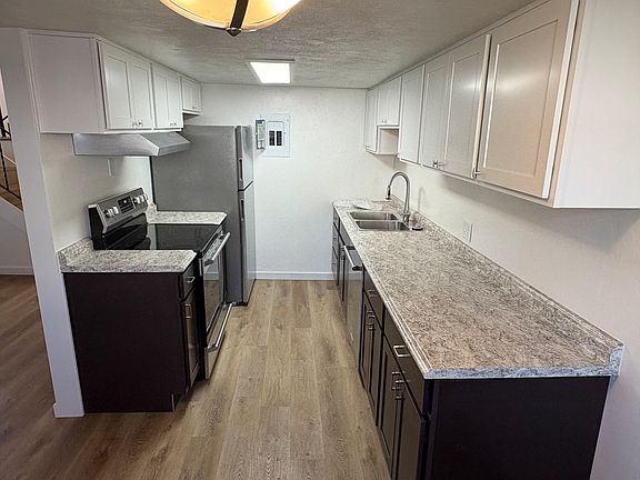 The kitchen has the decorator look new 2 toned cabinets and countertops. .There is a 5 burner glass top stove for cooking big meals. The stainless steel applicances loo