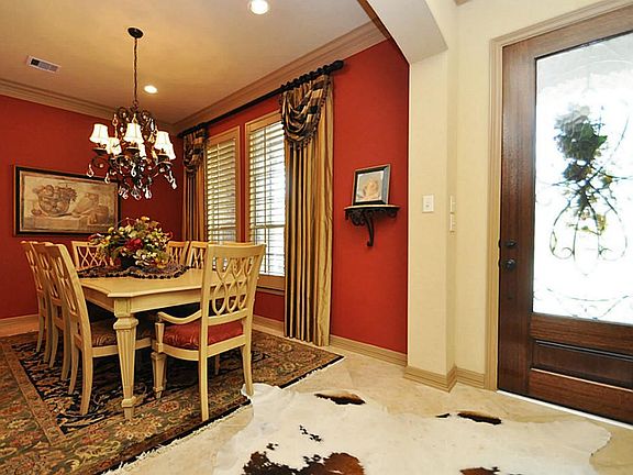 Elegant Dining Room with window treatments of wood blinds and drapery. Lots of Space for Entertaining.