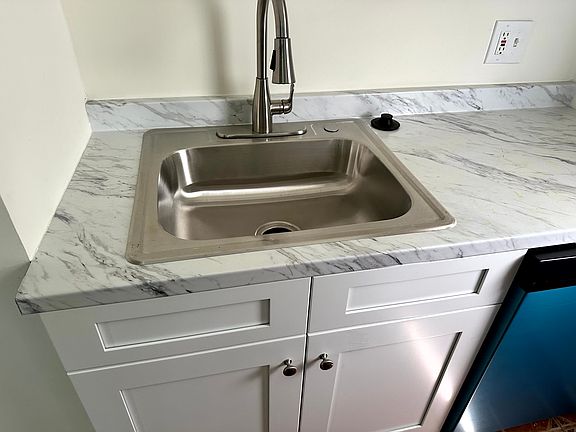 Updated kitchen counter tops and sink + dishwasher