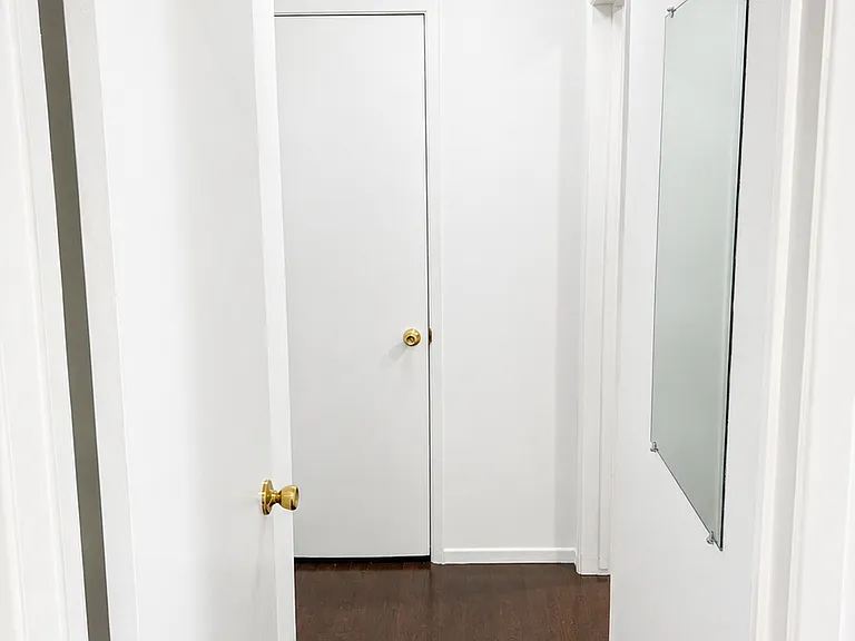 Clean interior hallway connecting the main living areas, bedroom, and bathroom.