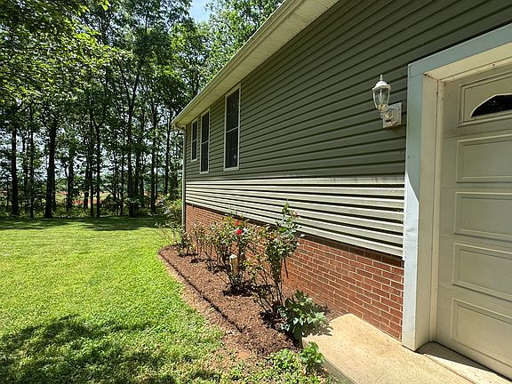 Side of home by driveway and 2-car garage - large yard - private - Landlord takes care of grass and leaves