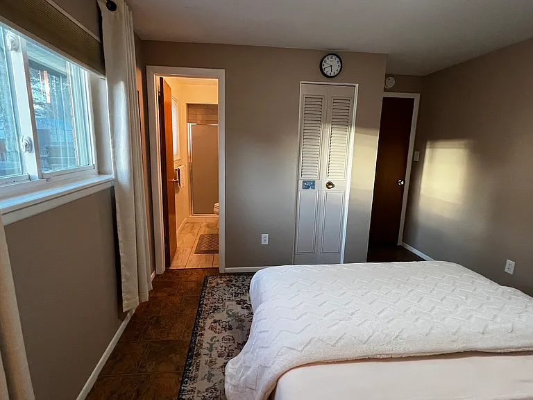 Alternate view of the garden-level bedroom showing the direct path to the attached bathroom.