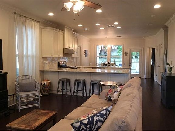 Open floor plan with wood floors, 9ft ceilings, crown molding, wide base boards & recessed lighting.