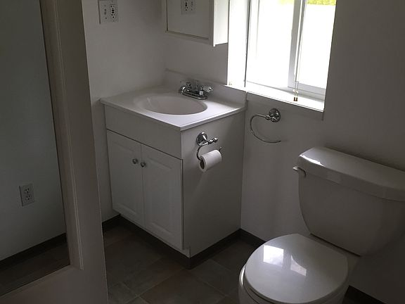 Upstairs, bathroom has shower, sink, and toilet