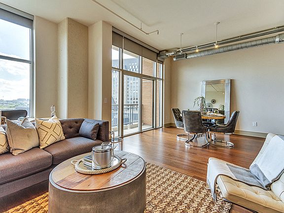 Spacious open concept floor plans with large living room and dining area with hardwood style flooring