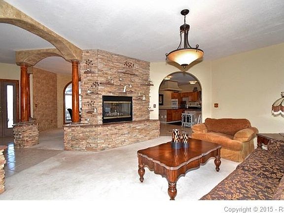 Living room shares see-thru gas fireplace with dining room