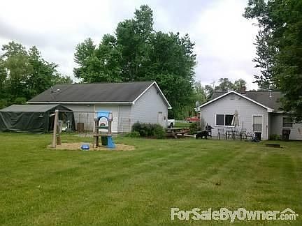 Back of House and Garage
						:
						Concrete patio has plenty of room for full-sized outdoor table and chairs.
