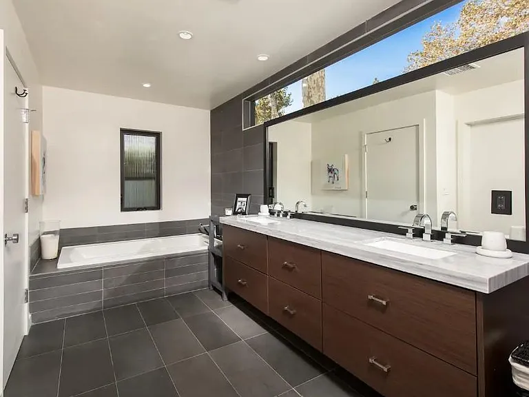Sink into the spacious, modern bathtub for a luxurious bathing experience in the master bathroom.