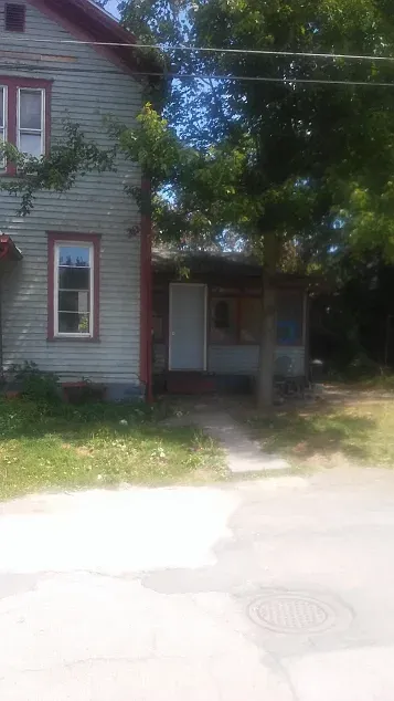 On the right is an enclosed sun room. - 207 S Mulberry St