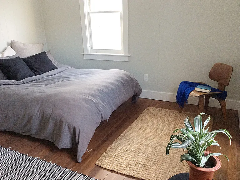 Main bedroom, hardwood floors, windows on two sides
