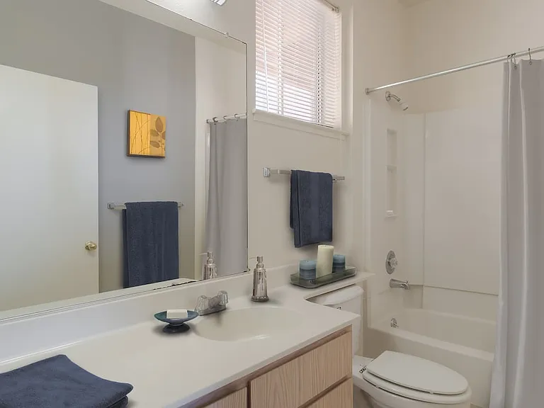 Classic Package I bath with light oak cabinetry, white laminate countertops, and hard surface flooring