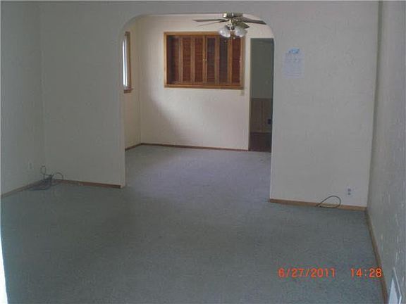 standing at front door looking into the house , living room and dining room