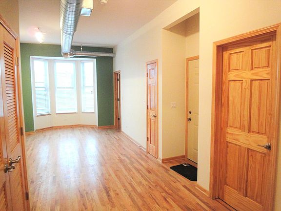 Front door, living room, bathroom door. High 10' ceilings, all hardwood floors