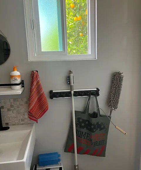 AC unit, broom, cleaning items.