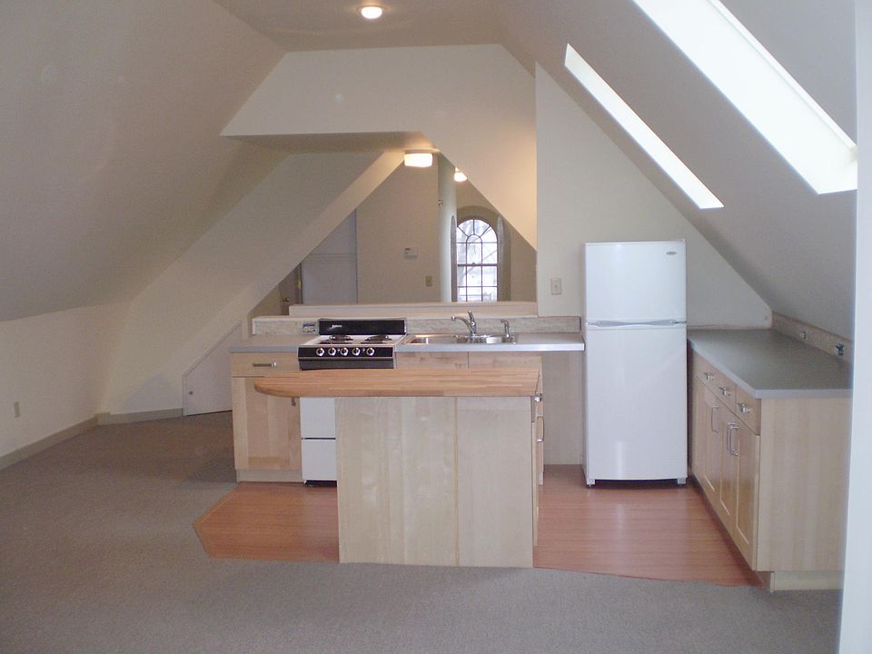 Living/kitchen looking toward bedroom area. The arched window is in the bedroom area.