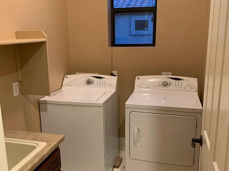 Upstairs laundry room with sink