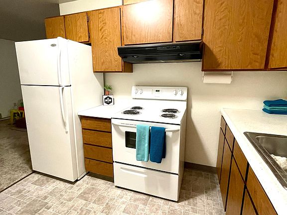 Kitchen includes full-sized fridge and stove, dishwasher, and garbage disposal.